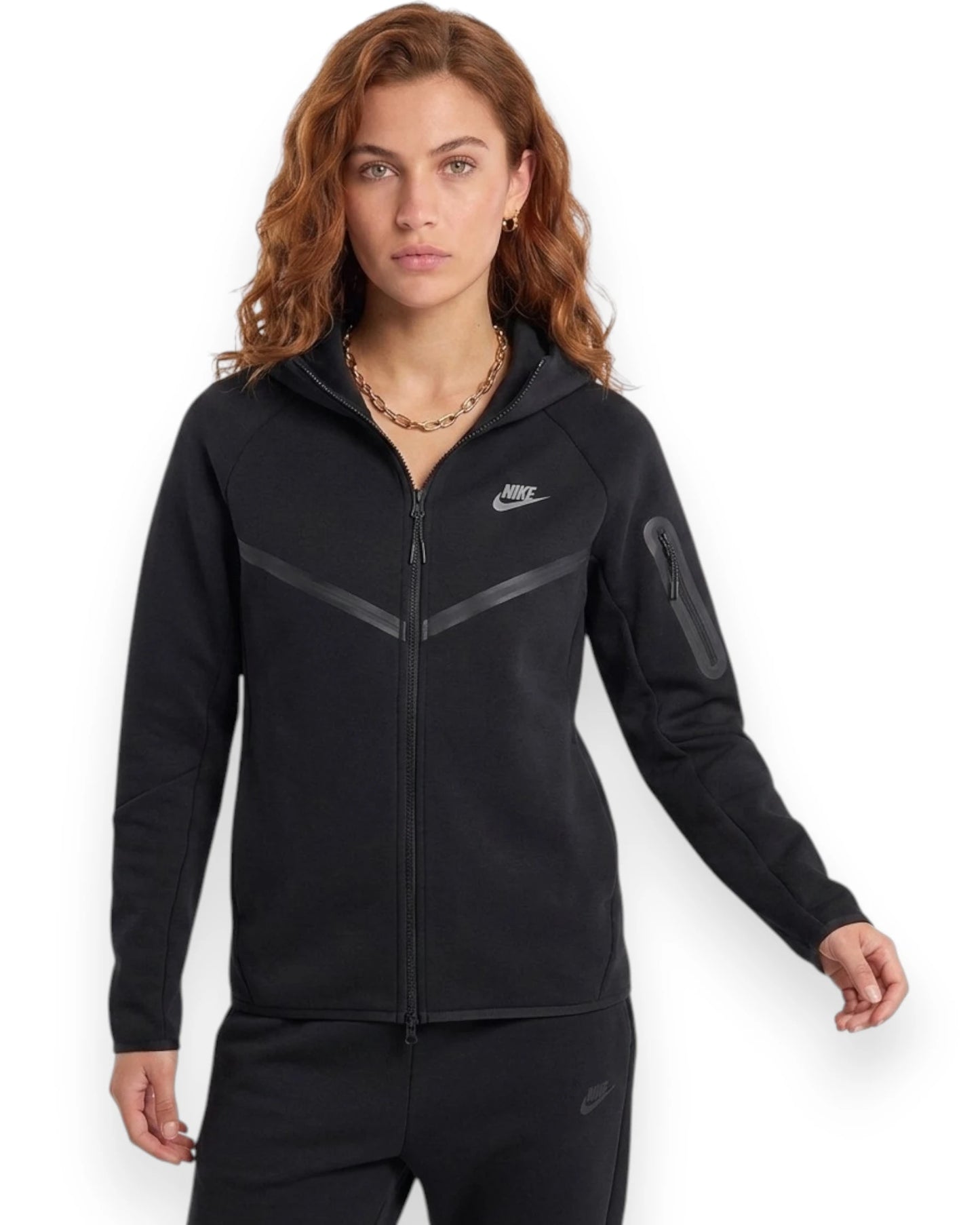 Woman wearing a black Nike tracksuit on a white background