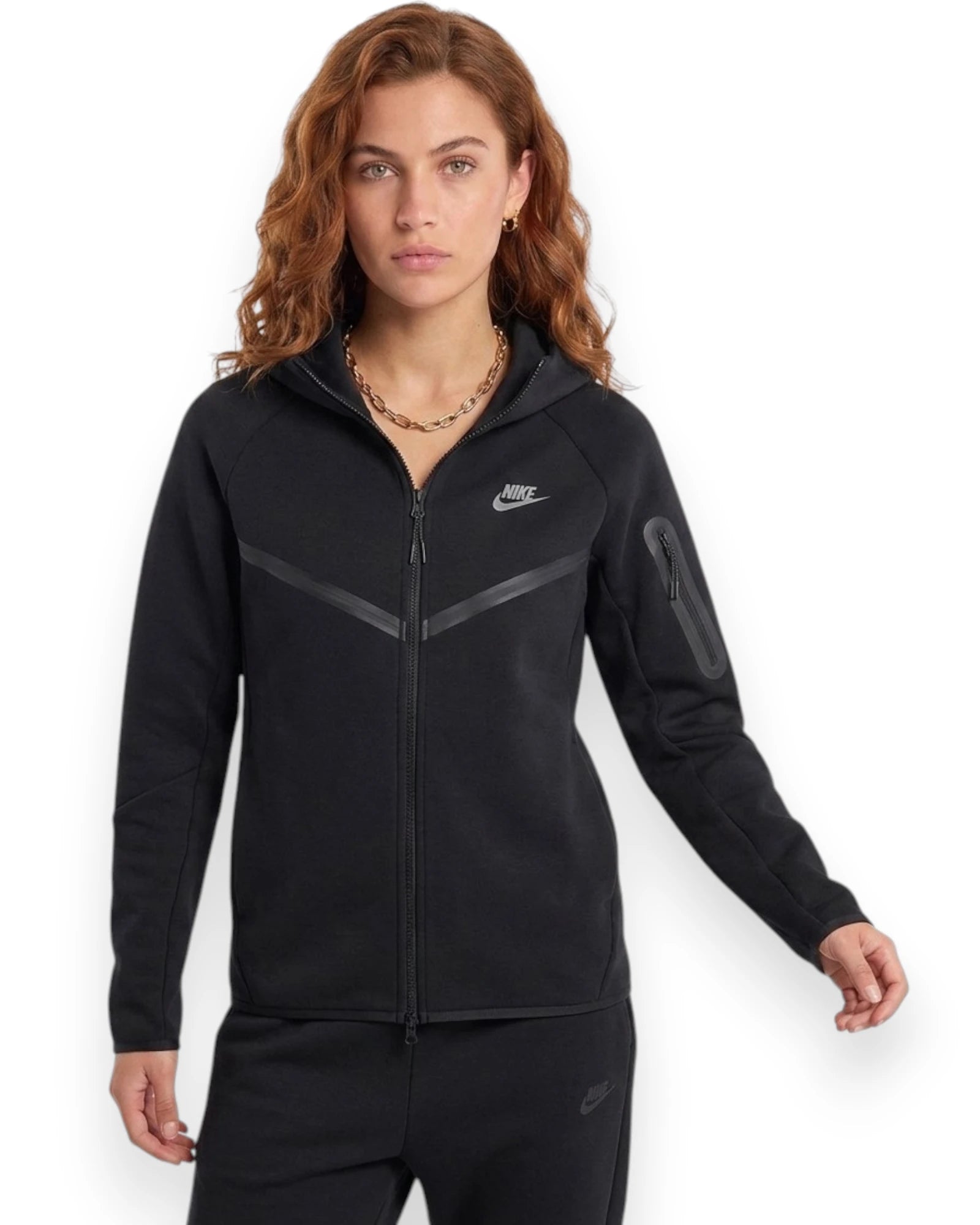 Woman wearing a black Nike tracksuit on a white background